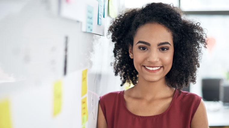 smiling women leaning on dry erase board