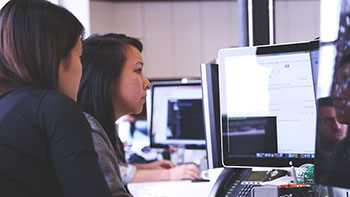 Two women looking at a computer